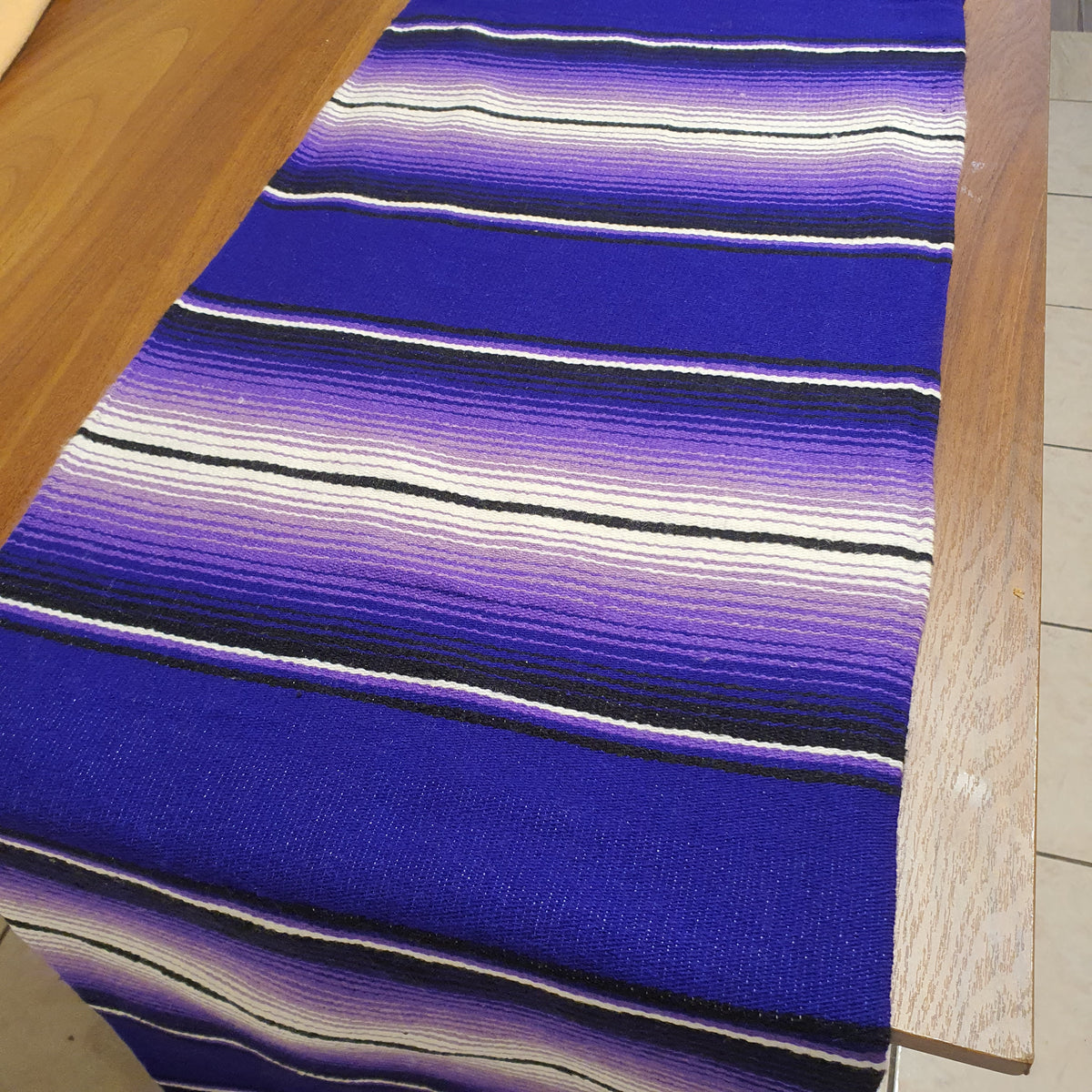 Close-up of a blue striped fabric on a wooden surface