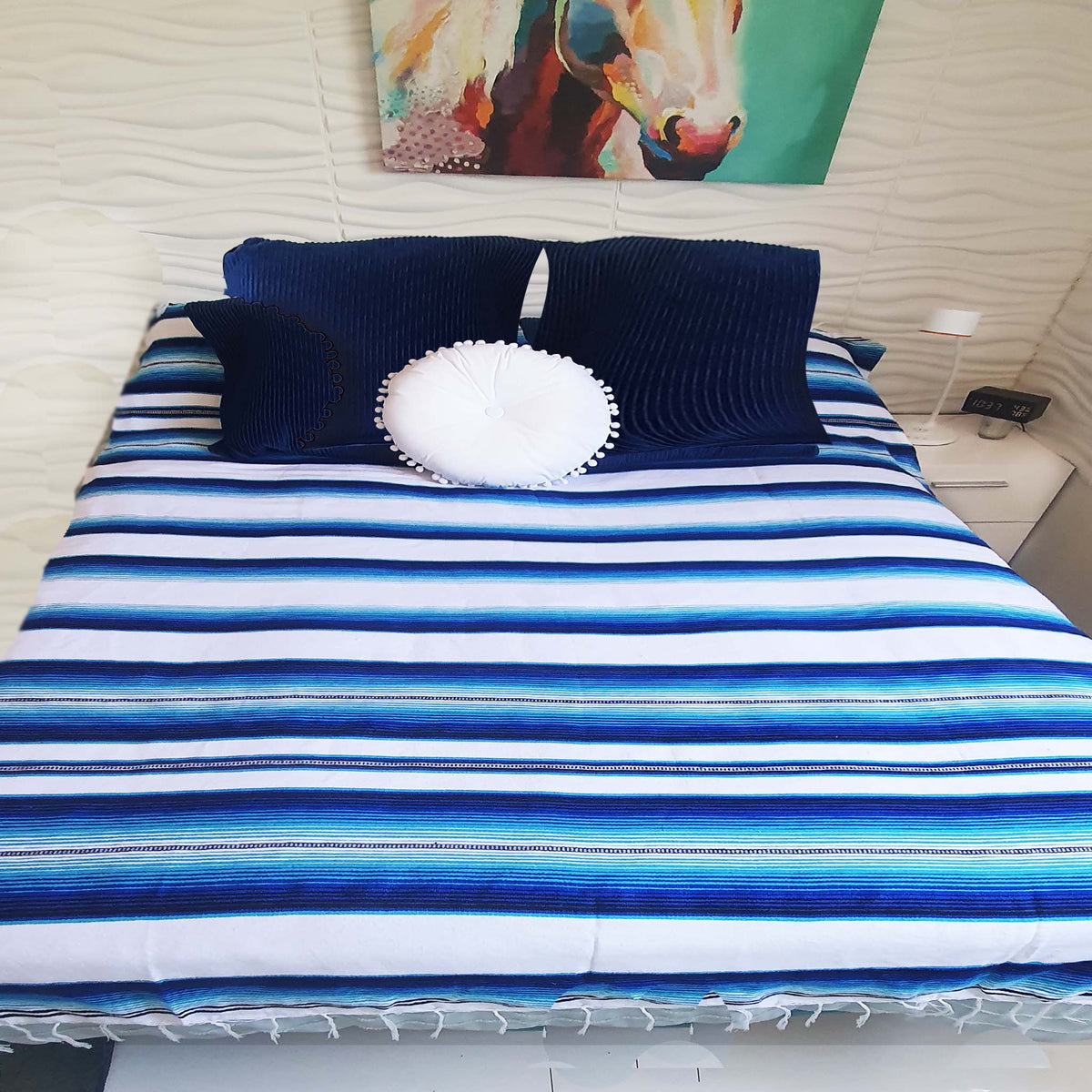 full size serape blanket, white, blue, on bed