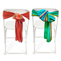 Two white chairs with colorful striped covers on a white background
