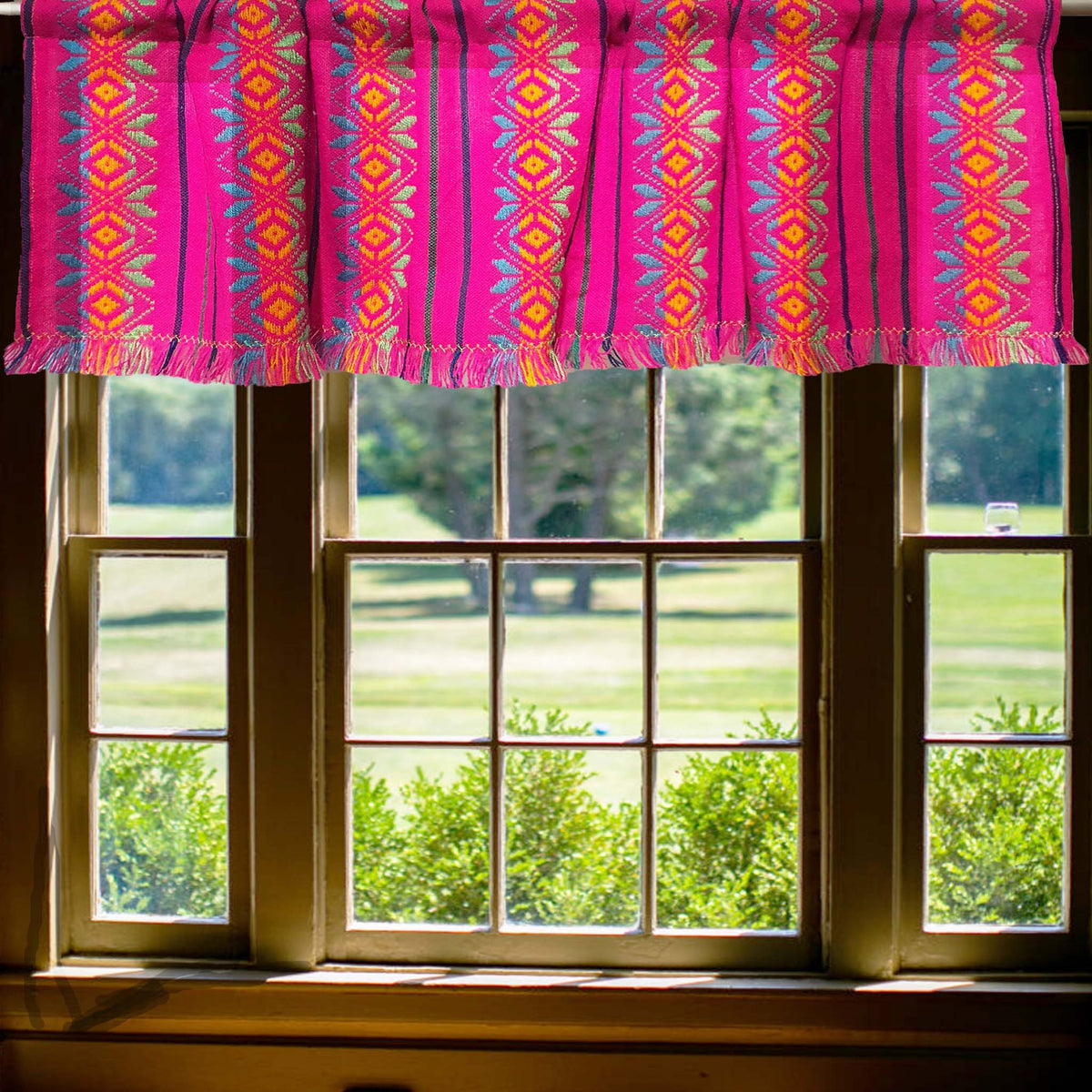 Mexican valance, hot pink, fuchsia, with fringes, on a window